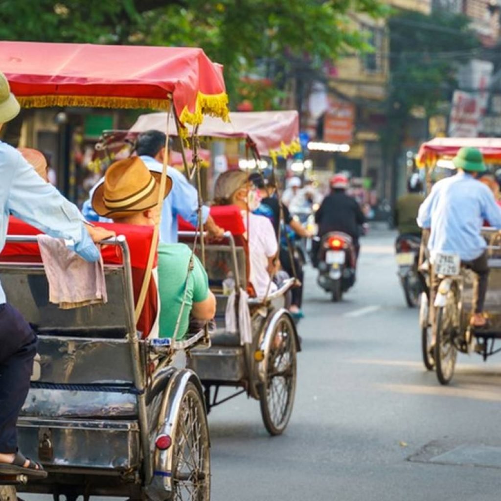 Tourists Enjoying Cyclo Ride in Hanoi