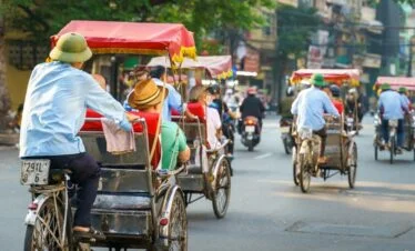 Tourists Enjoying Cyclo Ride in Hanoi